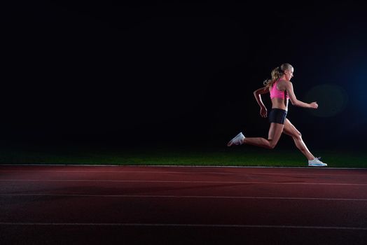 Athletic woman running onrace  track