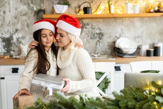 Mother and daughter in front of Christmas tree