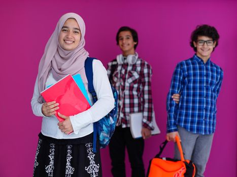 Arabic teenagers group, students team walking forward in future and back to school concept pink background