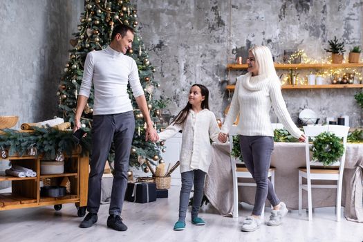 family, christmas, x-mas, winter, happiness and people concept - smiling family Preparing to celebrate Christmas