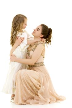 Beautiful young girl hugging her little sister. The concept of a happy childhood, family values. Isolated on white background.