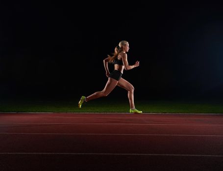 Athletic woman running onrace  track