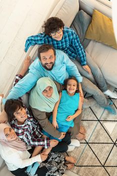 Top view photo of an Arab large family sitting in the living room of a modern house interior.Selective focus. High quality photo