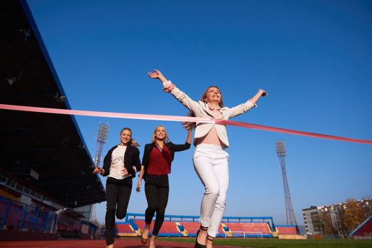 business people running together on racing track