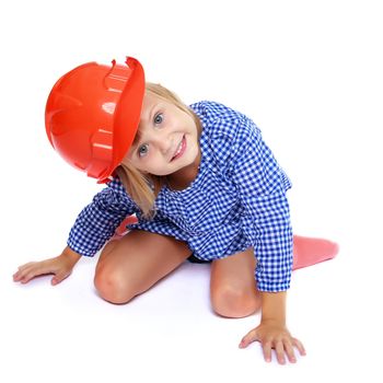 Construction and people concept - smiling little girl in protective helmet