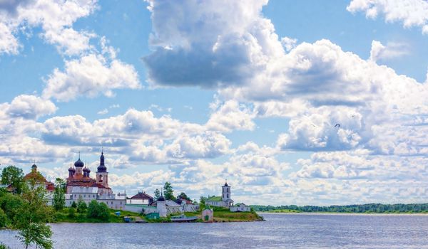 Beautiful view from the Volga river to the ancient Russian monastery. Sunny, fine day, blue sky and cumulus clouds. Concept history of Russia, tourism.