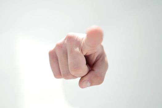 close up.a man's hand breaking through the paper and pointing somewhere .the concept of choice