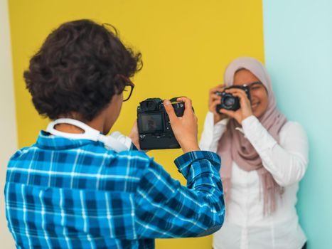 a photo of a young Arab teenager having fun with a camera. Selective focus. High quality photo