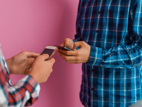 Arab teenagers group using smartphones for social media networking and sharing information for online education. Selective focus. High quality photo