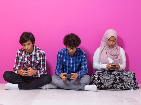 Arab teenagers group using smartphones for social media networking and sharing information for online education. Selective focus. High quality photo