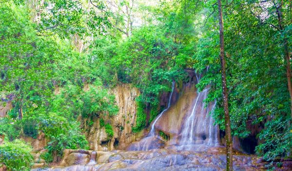 Beautiful waterfall among the thick greenery on the river Kwai, Thailand.