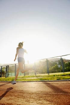 beautiful young woman exercise jogging and runing on athletic track on stadium at sunrise 