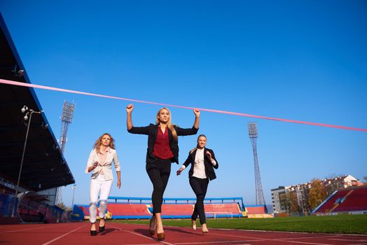 business people running together on racing track