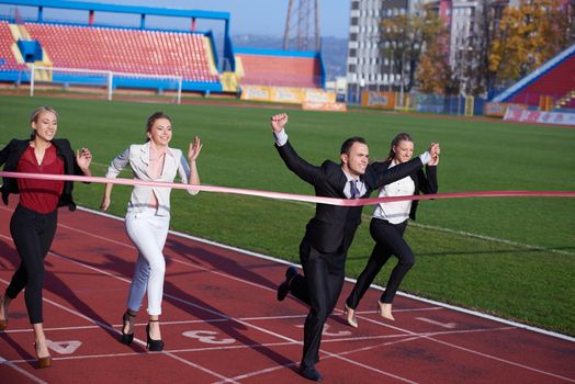 business people running together on  athletics racing track