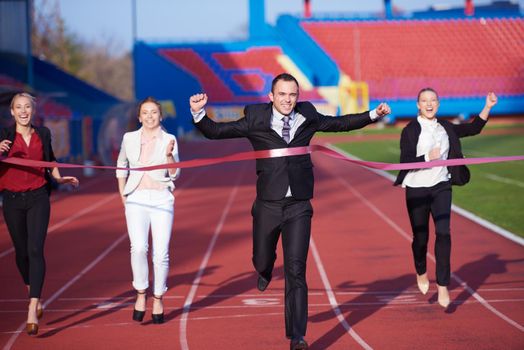 business people running together on  athletics racing track