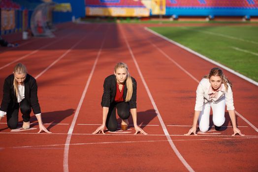 business people running together on racing track