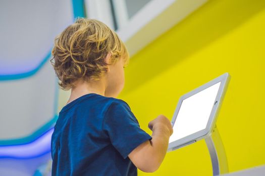 Boy playing with digital tablet. Children and technology concept.