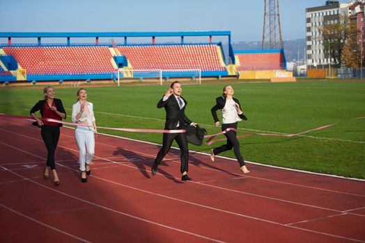 business people running together on racing track