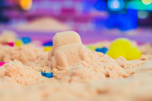 Figures from the pink kinetic sand The development of fine motor concept. Creativity Game concept.