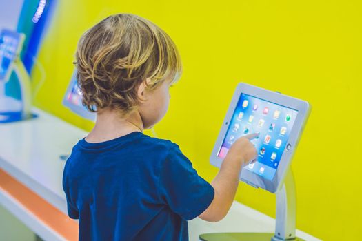 Boy playing with digital tablet. Children and technology concept.