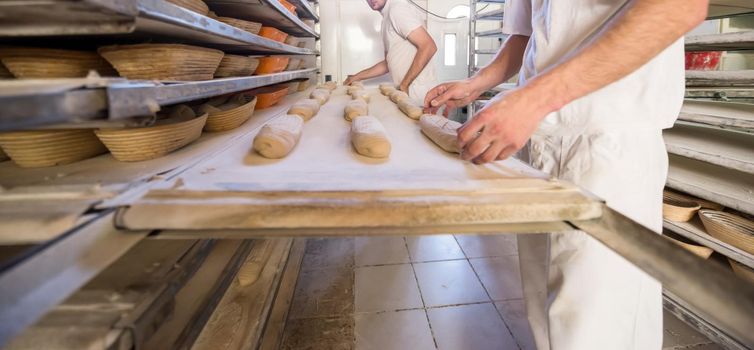 bakers preparing the dough for products In a traditional bakery