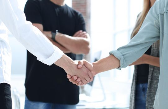 Business people shaking hands in the office after successful meeting.