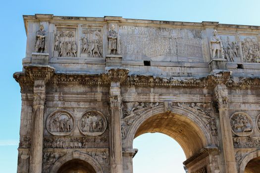 Closeup arch of Constantine in Rome, Italy. Concept of ancient landmarks and last minute cheap tours to Europe.