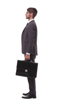 side view. confident businessman with leather briefcase.isolated on white background