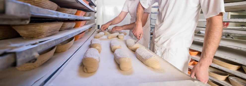 bakers preparing the dough for products In a traditional bakery