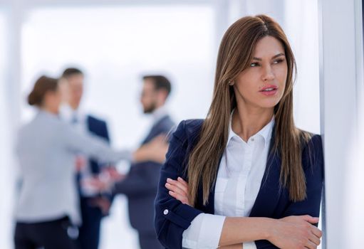 pensive business woman on blurred office background. photo with copy space