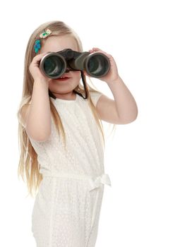 Beautiful little girl with long blond hair below the shoulders , in a white jumpsuit , keep the angle big binoculars . the girl looks straight into the camera. Close-up - Isolated on white background