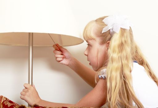 Interested in little girl includes a floor lamp in the room