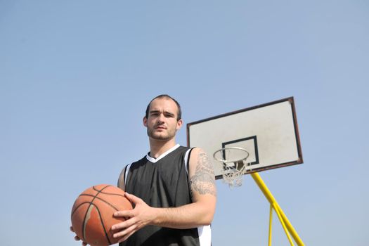 basketball player practicing and posing for basketball and sports athlete concept