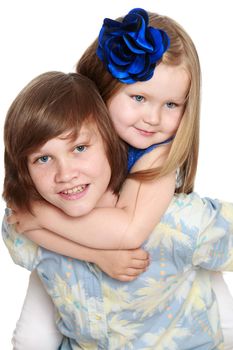 Gentle little girl hugging his neck of his older brother. Close-up-Isolated on white background