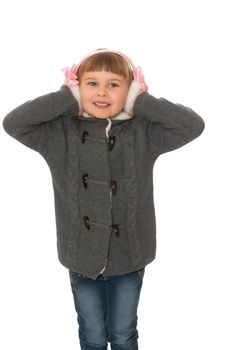 Cute little girl in grey coat covers ears with hands . close-up- Isolated on white background