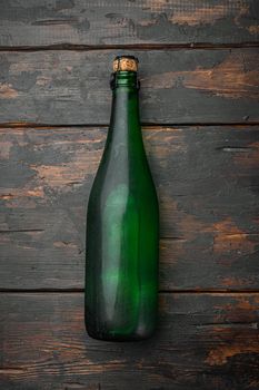Bottle of sparkling wine set, on old dark wooden table background, top view flat lay