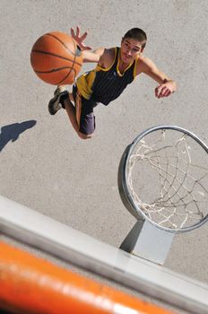 gorup of young boys who playing basketball outdoor on street with long shadows and bird view perspective