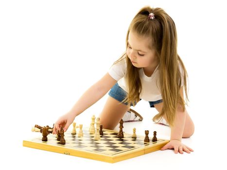 A little girl is playing chess. The concept of creative education of a child, training of thinking. Isolated on white background