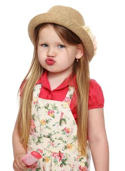 Portrait of cute little girl with long flowing blond hair to her waist. The girl pouted. In a hat and shorts , the girl is holding a Popsicle. Close-up - Isolated on white background