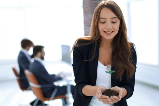 young business woman holding a fresh sprout.the concept of a startup