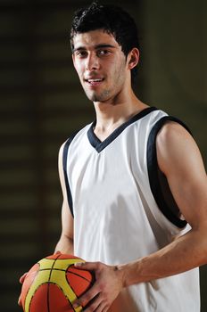 one basket ball game player standing in sport gym with ball