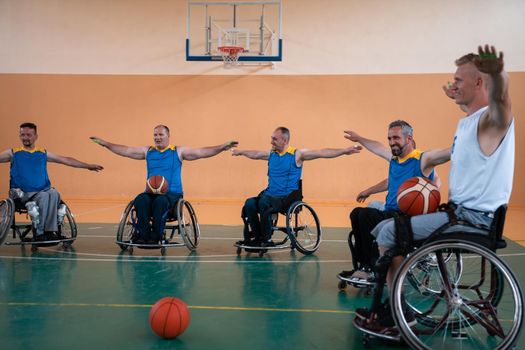 teams of basketball teams with disabilities warm up and do stretching exercises before training begins. Selective focus 