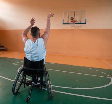 a cameraman with professional equipment records a match of the national team in a wheelchair playing a match in the arena. High quality photo. Selective focus 