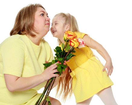 Young blonde mother, gently hugs her favorite little round-faced daughter. Family Idyll.With a beautiful bouquet of tea roses.Isolated on white background.