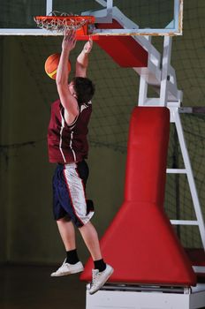 one healthy young  man play basketball game in school gym indoor
