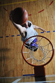 one healthy young  man play basketball game in school gym indoor