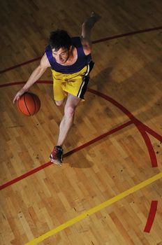 one healthy young  man play basketball game in school gym indoor