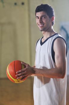 one healthy young  man play basketball game in school gym indoor