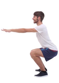 Full length.active male performs squats with straight arms. isolated on white background