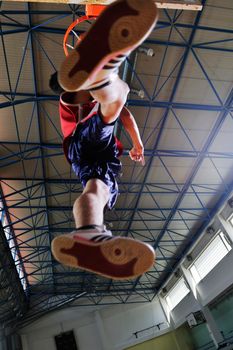 young healthy man play basketball game indoor in gym